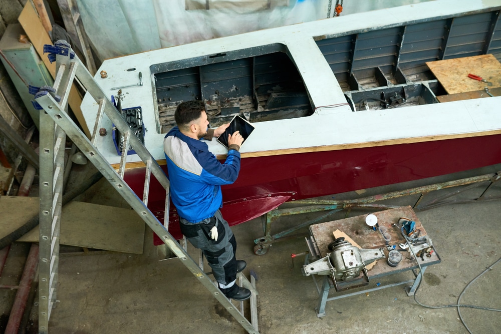 Worker using tablet on boat