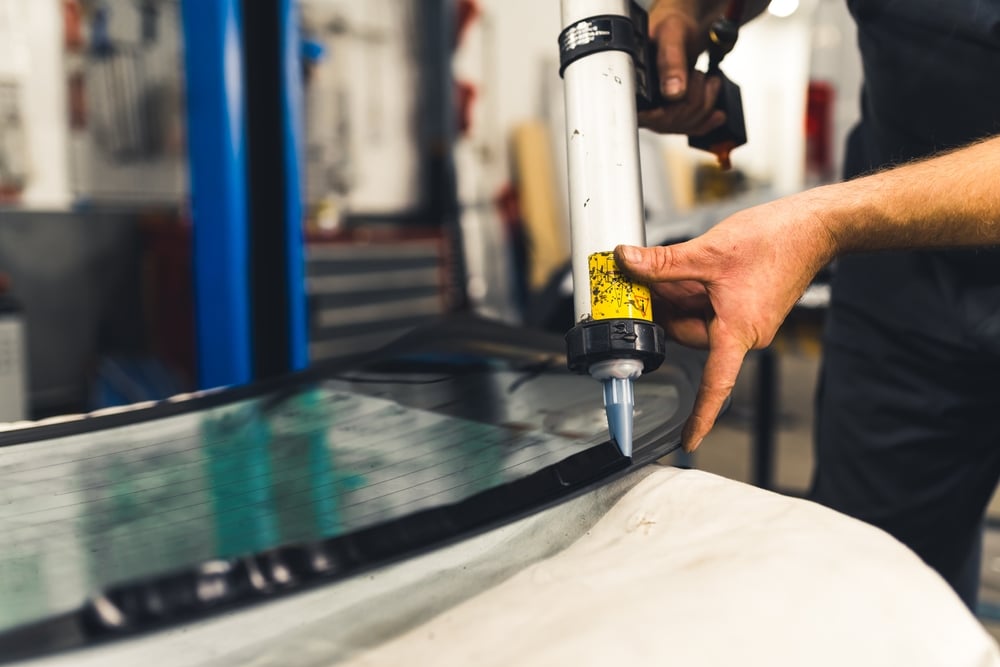 Worker applying adhesives